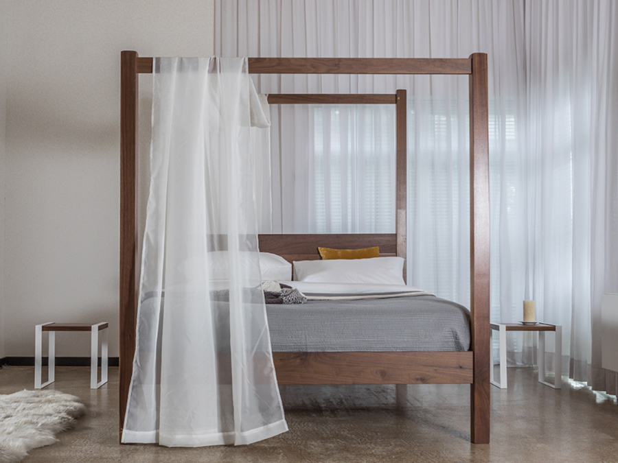 canopy bed in front of window